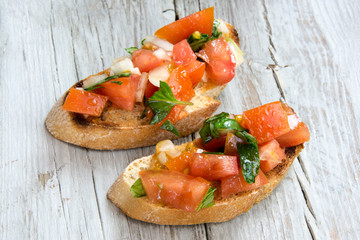 Bruscheta, antipasti Typical Italian with tomato, basil and toast