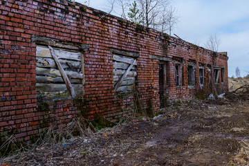 remains of a farm building of concrete slabs and red bricks