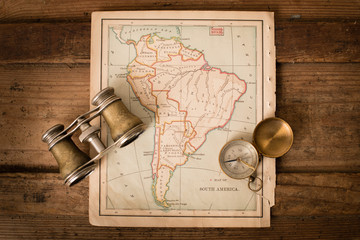 Binoculars and Compass on 1870 Map of South America – World Travel