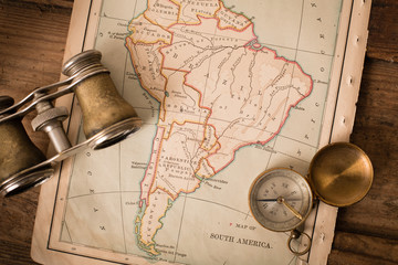 Binoculars and Compass on 1870 Map of South America – World Travel