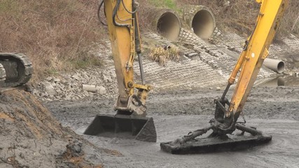 Digging Deep fishing hole along shore in Farm Pond with backet Amphibious Long Reach Excavator