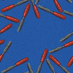 bit tool with orange handle on blue denim background with space for text