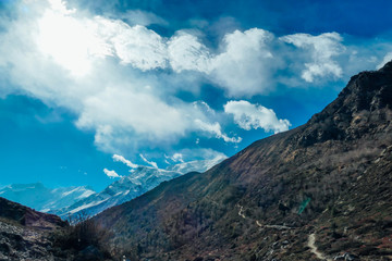 Harsh slopes of Manang Valley, Annapurna Circus Trek, Himalayas, Nepal, with the view on Annapurna Chain and Gangapurna. Dry and desolated landscape.  High mountain peaks, covered with snow.
