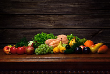 Fototapeta na wymiar Vegetables and fruits on the oak table and on wooden background.