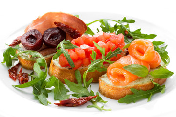 Sandwiches with fish, bacon, tomatoes and arugula on a white background