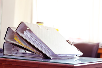 Stack of documents placed on a business desk in a business office.