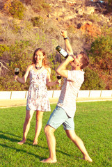 Obraz premium Man gives a concert for his woman with bottle of wife. Time of humor.
