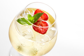 Cocktail with strawberries and ice in a glass.