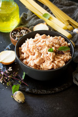 Minced meat, pasta and ingredients for cooking minced meat in a bowl on a slate. Copy space.