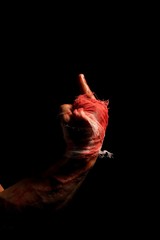 Male bloody hand in bandage view in the dark