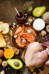 Balanced food background. Protein foods, fruits, juice and vegetables on a rustic wooden background. Healthy eating and diet concept. Top view flat lay background. Free space for your text.