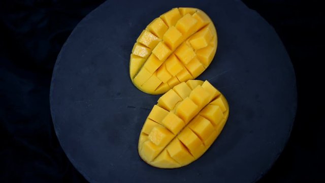 Mango. Tropical Fruits. On a black background. Top view.
