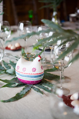 Festive table setting with fern leaves and forest flowers