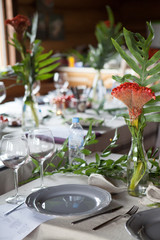 Festive table setting with fern leaves and forest flowers
