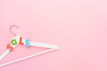 White hangers with sale text on pink background