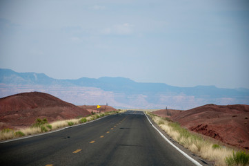 Road between red sand hills in USA