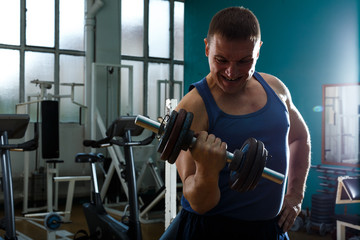 Close up portrait of man with dumbbell