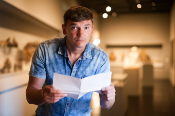 Man visiting museum with leaflet