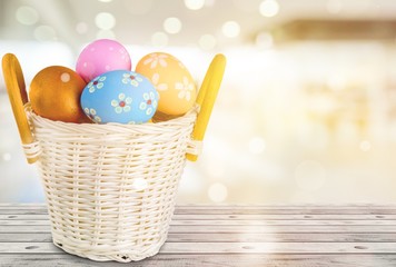 Easter basket filled with colorful eggs on a white background