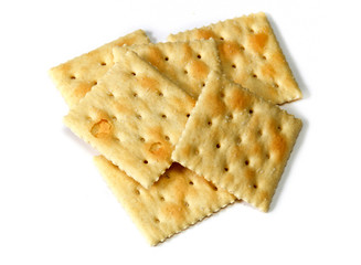 Small stack of soup crackers, also known as soda crackers and saltines over white, not isolated.