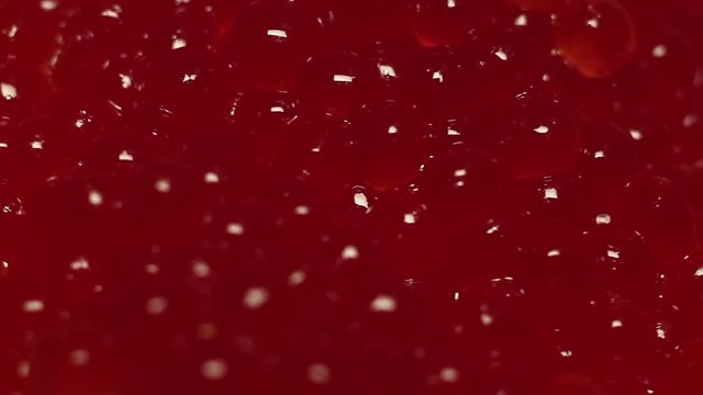 Red caviar background close up rotation,