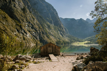 Covered pier over a german lake among mountains on sunset.