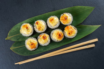 eight rolls on a slate Board, on bamboo leaves, top view