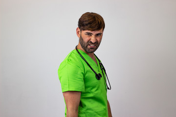 Portrait of male veterinary doctor in green uniform with brown hair resentment, their back facing...