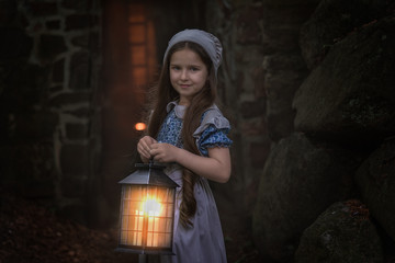 A girl in retro clothes stands with a lantern near the fortress wall.