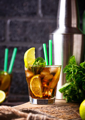Cuba libre cocktail with mint and lime