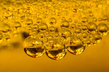 air bubbles in golden liquid abstract