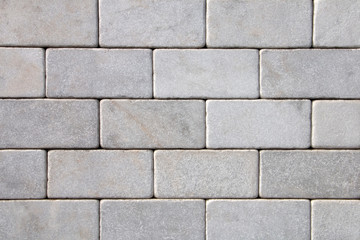 Brick wall of white natural stone.