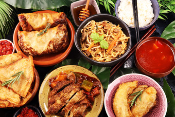 Assorted Chinese food set. Chinese noodles, fried rice, peking duck, dim sum, spring rolls. Famous Chinese cuisine dishes on table. Chinese restaurant