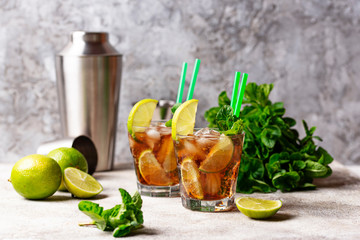 Cuba libre cocktail with mint and lime