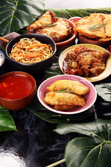 Assorted Chinese food set. Chinese noodles, fried rice, peking duck, dim sum, spring rolls. Famous Chinese cuisine dishes on table. Chinese restaurant