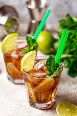 Cuba libre cocktail with mint and lime