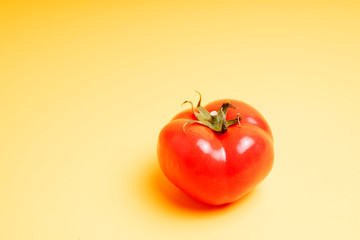 red tomato on a yellow background