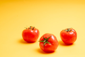 red tomatoes on a yellow background