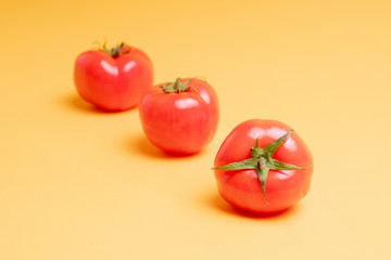 red tomatoes on a yellow background
