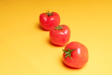 red tomatoes on a yellow background