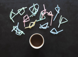 Broken plastic coffee straws and cap of coffee. 