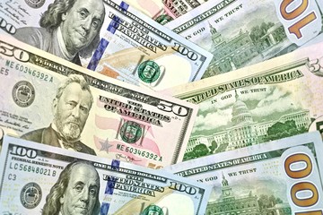 American dollars laid obliquely overlapped. On the whole frame.