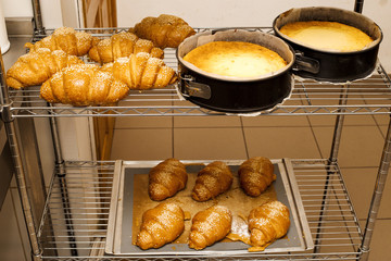 Fresh ruddy buns on the rack. bakery. kitchen.