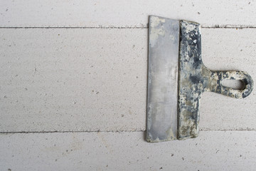 Spatula on the concrete floor close-up.