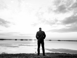 Man on the background of the sunset on the lake.