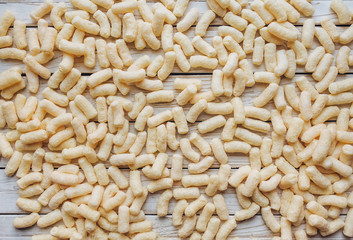 Background of yellow corn sticks. The view from the top. A quick snack concept.