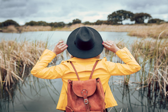 Girl with black hat and yellow jacket