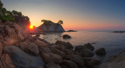 Landscape of beach at sunrise in Lloret de Mar, Spain coast. Costa Brava sea nature in morning sunshine