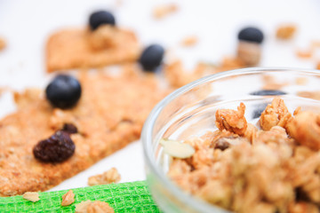 Crunchy muesli cookies and blueberries on green napkin, Breakfast cereals isolated on white background, selective focus, top view