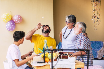 People family enjoying bbq. Wood table with natural meal. Senior grandparents.